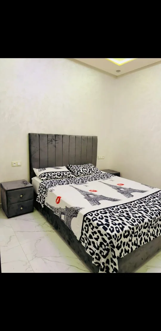 Double bedroom with patterned bed linen